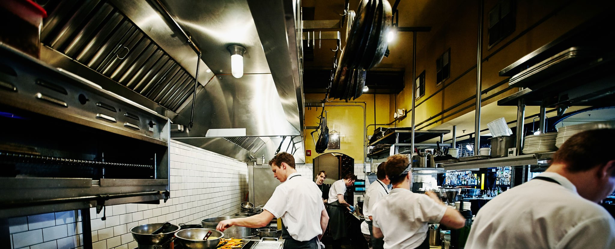 Chef and kitchen staff preparing dinner in restaurant kitchen